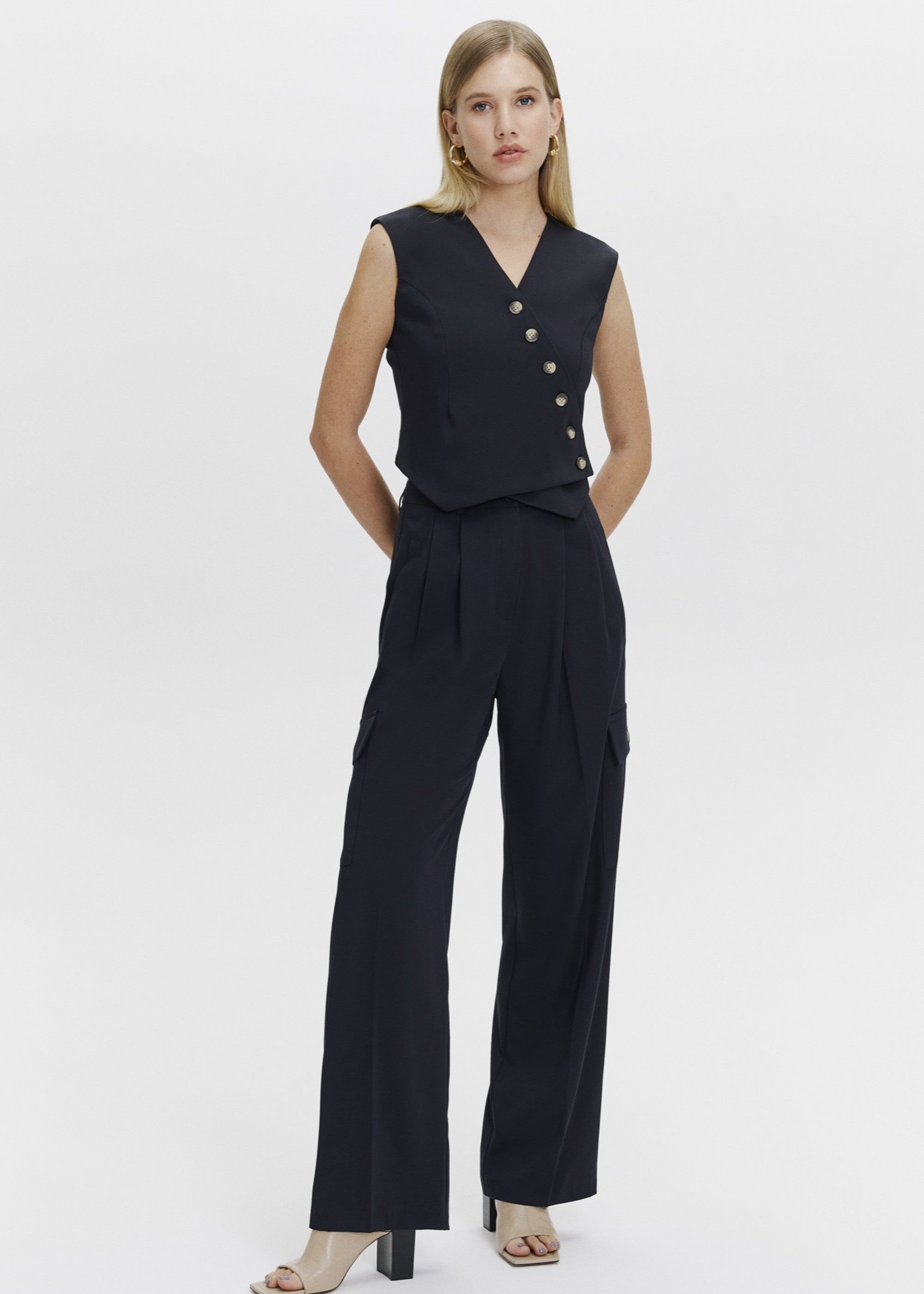 Asymmetric detailed vest and cargo trousers