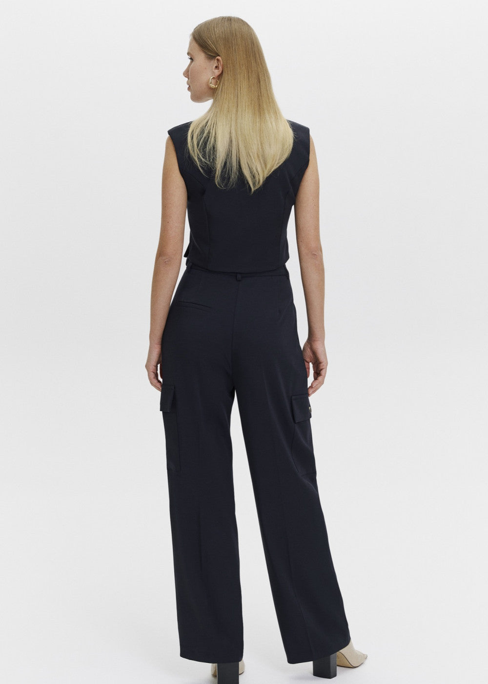 Asymmetric detailed vest and cargo trousers